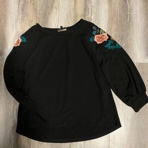 Black W5 top with floral detail on sleeves.